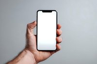 Male hand holding modern smartphone with blank white screen against gray background for app presentation and mockup design.