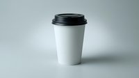 White disposable coffee cup with black lid on gray background for branding mockup and cafe marketing materials.