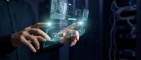 Businessman holding transparent digital tablet displaying holographic building wireframe and architectural data visualization in dark tech environment.
