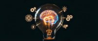Creative lightbulb with glowing brain inside surrounded by golden gear icons representing innovation, artificial intelligence and problem-solving concepts.