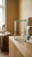 Modern glass block on wooden sideboard in warm minimalist living room interior with natural light and neutral earth tones for contemporary home decor.