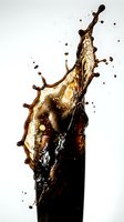 Dynamic cola splash erupting from glass with dramatic droplets and foam against clean white background for beverage advertising and refreshment concepts.
