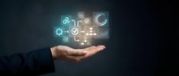 Businessman hand holding glowing digital icons representing business management, analytics, and technology solutions for corporate strategy and operations.