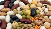 Colorful assortment of mixed legumes and beans including kidney beans, black beans, chickpeas, lentils and pinto beans for healthy cooking and nutrition.
