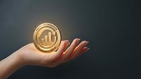 Female hand holding glowing golden coin with bar chart symbol, representing financial growth, investment success, and wealth management for business concepts.