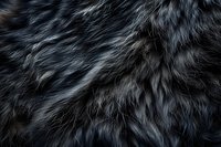 Luxurious dark gray and silver fur texture closeup perfect for fashion, textile, and luxury design backgrounds. Natural animal fur pattern with soft focus effect.