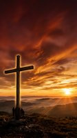 Wooden cross silhouetted against dramatic sunset sky with golden clouds over mountain landscape for spiritual and religious concepts.