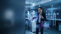 Professional businessman analyzing holographic data visualization and digital interface technology in modern office environment for business analytics.