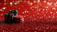 Stacked poker chips on red glittery surface with bokeh lights background, creating dramatic casino atmosphere and luxury gaming concept.