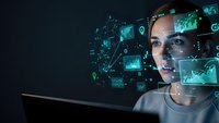 Young professional woman analyzing digital data visualization with holographic charts and graphs floating around her face in futuristic technology concept.