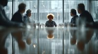 African American businesswoman leading corporate meeting in modern conference room with diverse team of professionals discussing strategy.