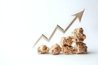 Growing upward arrow chart with gold nuggets showing increasing value and financial growth trend on white background, business concept visualization.