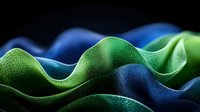 Abstract wavy surface with green and blue textured gradient pattern creating dynamic flowing curves and undulating shapes against dark background.