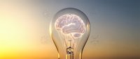Glowing light bulb with illuminated brain inside against sunset sky, representing innovation, creativity, and intelligent ideas for business and technology concepts.