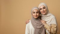 Two Muslim women in hijabs smiling together on beige background, showing warmth and family bond. Copy space for text.
