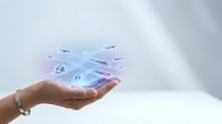 Woman's hand holding glowing digital network with connected car icons and data streams, representing smart transportation technology and autonomous vehicle connectivity solutions.