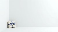 Small white gift box with blue ribbon bow on white surface, isolated and ready for holiday, celebration, and promotional design use.