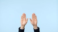 Two hands raised up showing palms in stop gesture against light blue background for business communication and body language concepts.