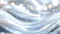 Shimmering silver waves with glitter sparkles on soft flowing curves create elegant abstract background in cool winter tones and dreamy bokeh effect.