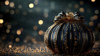 Luxurious black and gold decorative pumpkin on glittering surface with bokeh lights in background, elegant autumn seasonal decor for festive occasions.