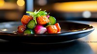 Glazed pork belly bites garnished with fresh microgreens, radish, and edamame on black ceramic plate, dramatic restaurant lighting creates appetizing mood.