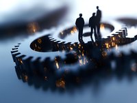 Silhouettes of two businessmen standing on glowing mechanical gears against dark background, representing business partnership and technological innovation.