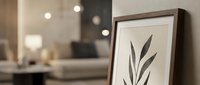 Modern minimalist botanical wall art with black leaf silhouette in wooden frame on white background, contemporary home decor for living room interior design.