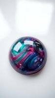 Colorful iridescent sphere with swirling metallic patterns in purple, teal and magenta hues on white background for modern design projects.