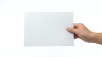 Hand holding blank white paper card on transparent background isolated for mockup design presentations and marketing materials.