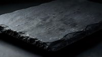 Dark slate stone tiles with rough natural edges and textured surface for modern interior design and architectural projects.