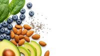Fresh healthy superfood ingredients with blueberries, almonds, avocado slices and spinach leaves arranged on white background for nutritious meal preparation.