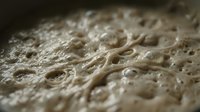 Close-up of sliced bread showing porous crumb structure with air holes and soft texture, suitable for food photography, baking content, and culinary backgrounds.