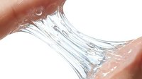 Close-up of clear gel or slime stretching between two fingers against white background, demonstrating elasticity and texture for skincare, cosmetics, or product testing applications.