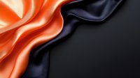 Luxurious orange and black silk fabric with flowing waves and elegant drape creating sophisticated textile background for fashion and design projects.