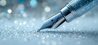 Fountain pen nib with metallic silver finish on glittery blue background with bokeh effect. Close-up macro photography shows intricate details and craftsmanship.