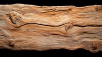 Natural wooden texture with wavy grain pattern and knots on dark background, macro photography showing detailed wood surface structure and organic flow lines.