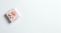 Pink gift box with ribbon bow on white background, isolated and ready for holiday, celebration, and promotional design use.
