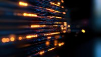 Glowing digital code lines with orange light streaks on dark background, abstract technology pattern showing data transmission and programming concept.