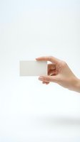 Hand holding blank white business card on clean background for corporate identity and branding mockup design projects.