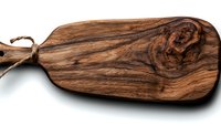 Rustic wooden cutting board with natural wood grain pattern and rope handle isolated on white background for kitchen and food photography styling.