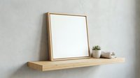 Empty wooden frame on floating shelf with small plant and cup, minimalist home decor mockup for artwork display and interior design projects.