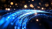 Abstract blue light trails with glowing bokeh effect on dark background, creating futuristic technology concept for digital communications and data transfer.