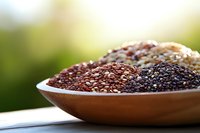 Variety of raw organic chia and flax seeds in wooden bowl on natural background, healthy superfood rich in omega-3 fatty acids and fiber.