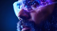 Close up profile of African American man with beard wearing futuristic glowing glasses with digital elements and neon blue purple lighting effects against dark background.