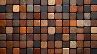 Wooden mosaic wall panel with square blocks in various brown and orange tones creating modern geometric pattern. Natural wood texture surface for interior design.