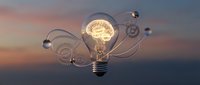 Glowing lightbulb with gear symbols and flowing wire connections against sunset sky backdrop, representing innovation, creativity, and business solutions.