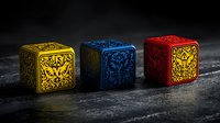 Decorative gaming dice with ornate pattern in yellow, blue and red colors on dark textured background. Mystical board game elements with intricate floral design.