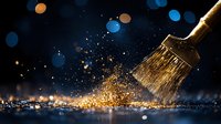 Paint brush with gold glitter splash against dark background with blue bokeh lights, creating magical artistic atmosphere for creative design projects.