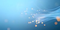 Glowing optical fiber strands with bokeh light effects on blue background, creating futuristic technology network concept for communications design.
