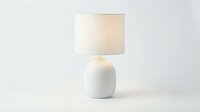 Minimalist white ceramic table lamp with fabric shade isolated on white background, perfect for interior design and home decor projects.